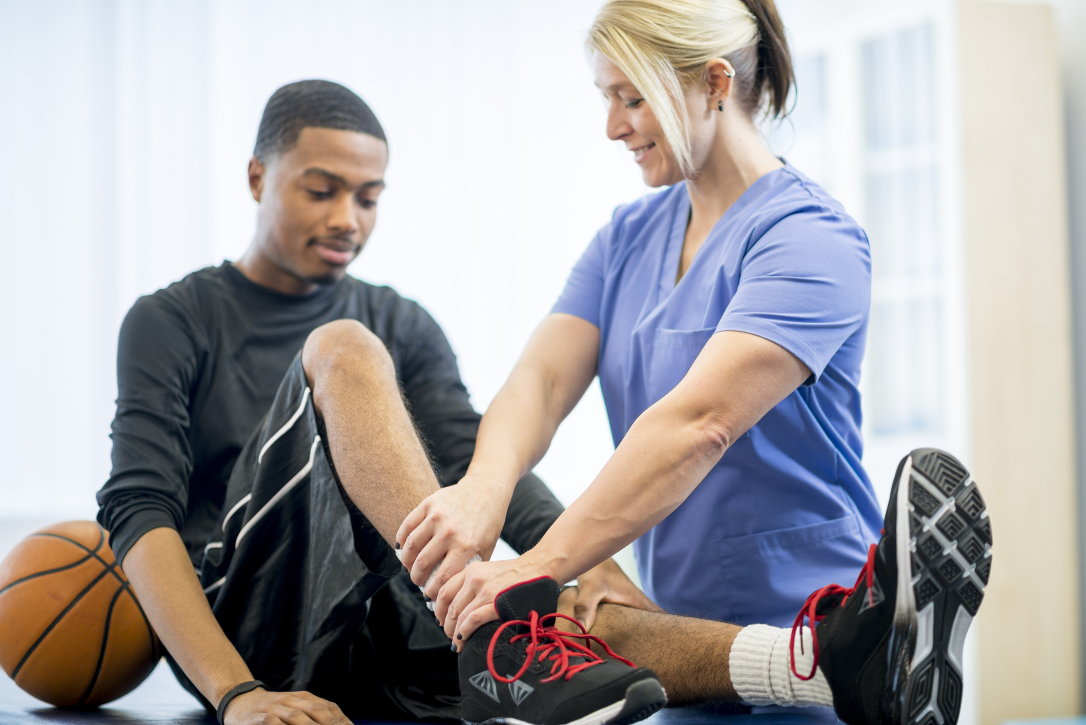 A sports medicine doctor examining an athlete.