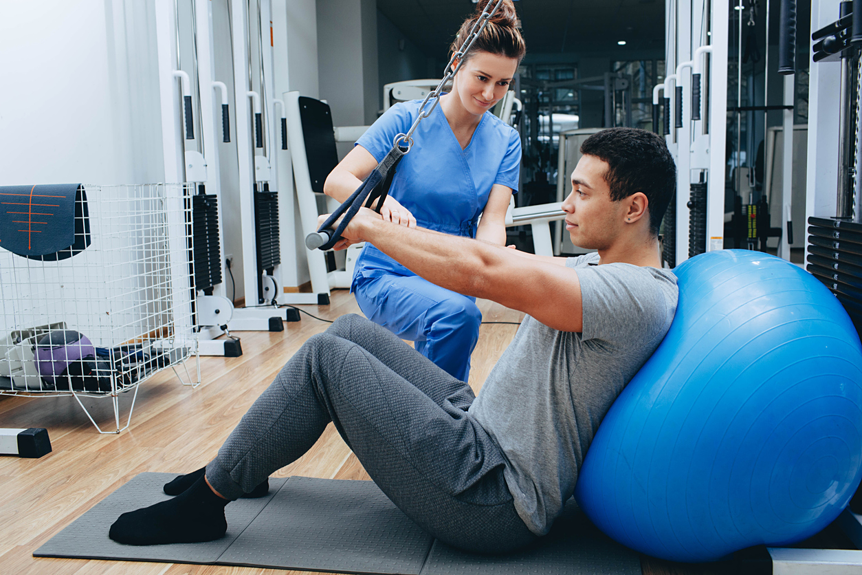 A sports medicine doctor explaining injury prevention techniques to an athlete