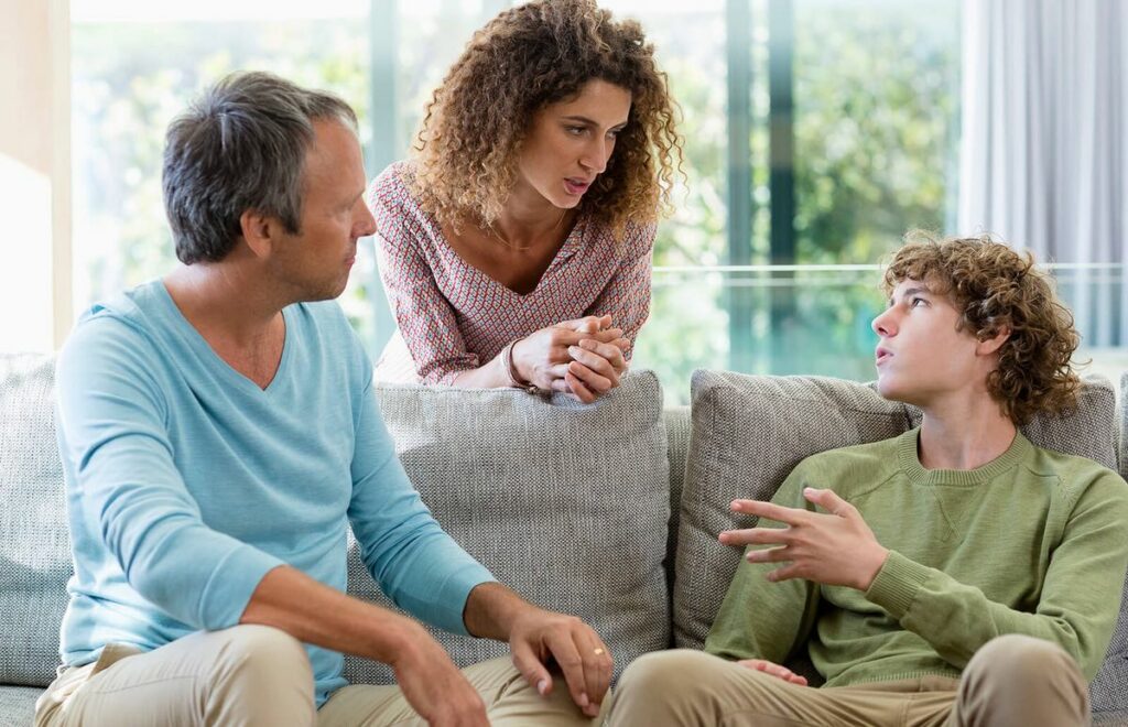 Parent and teenager discussing health.