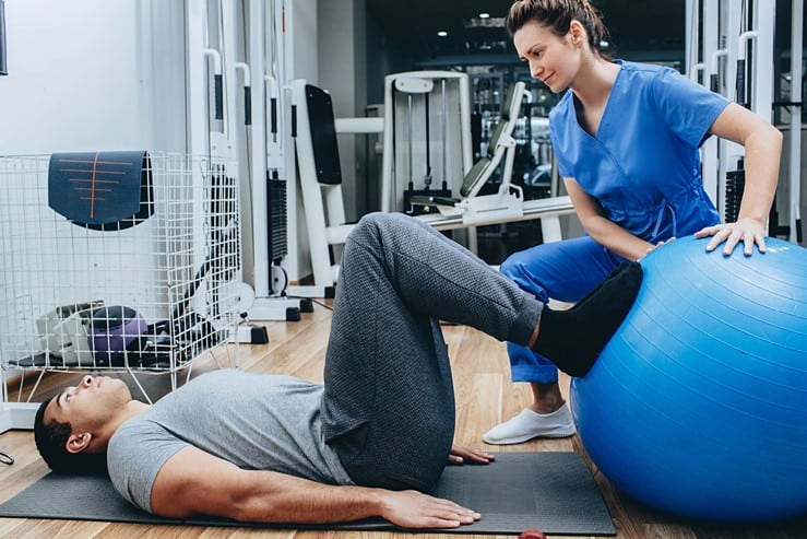 A physical therapist assisting a patient with exercises.
