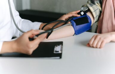 doctor checking blood pressure