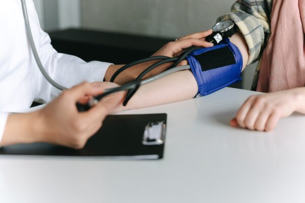 doctor checking blood pressure