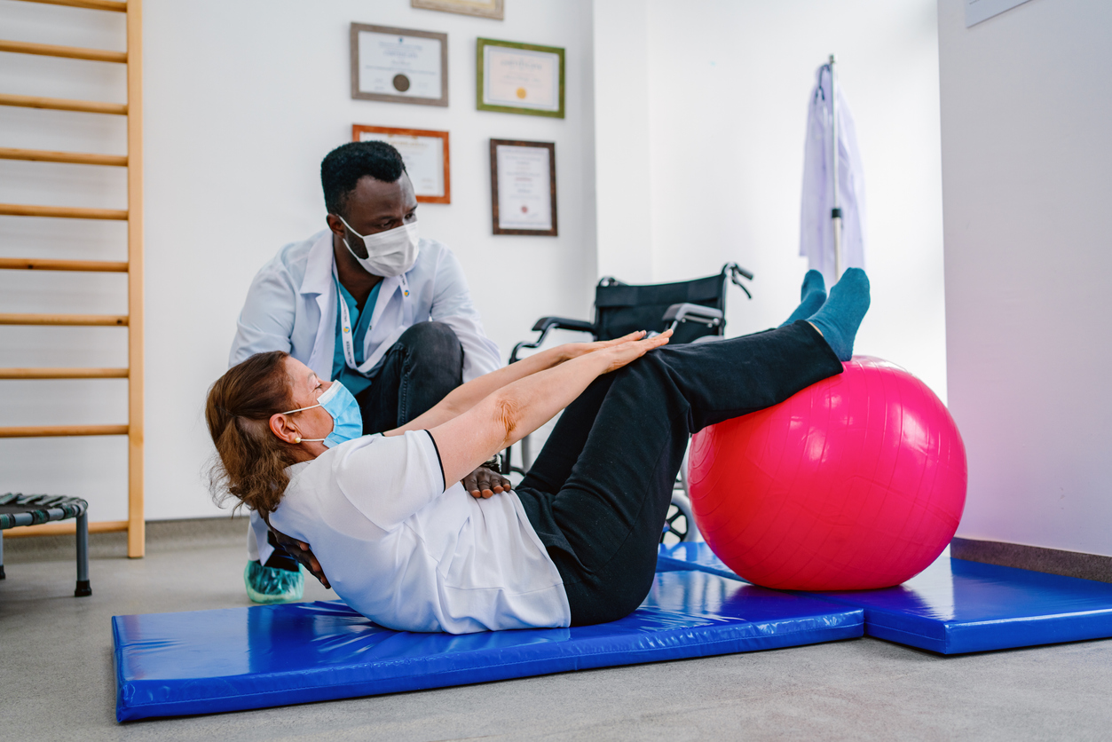 physical therapist assisting a patient during a rehabilitation exercise
