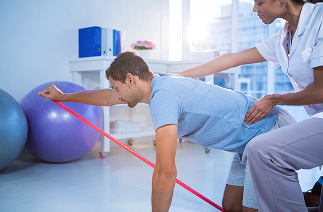 physical therapist assisting a patient with exercises.